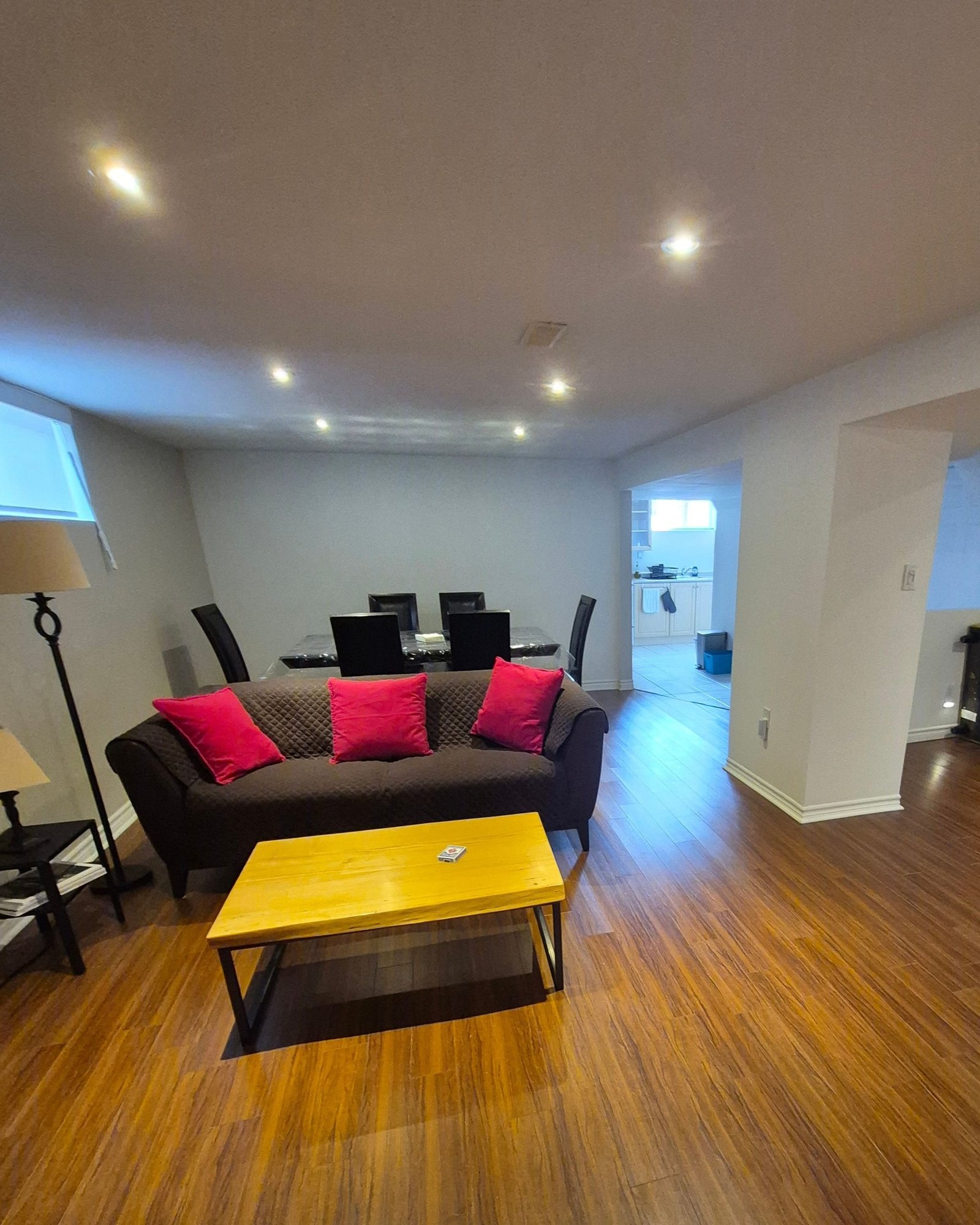 Living area with sofa, coffee table, and dining space behind